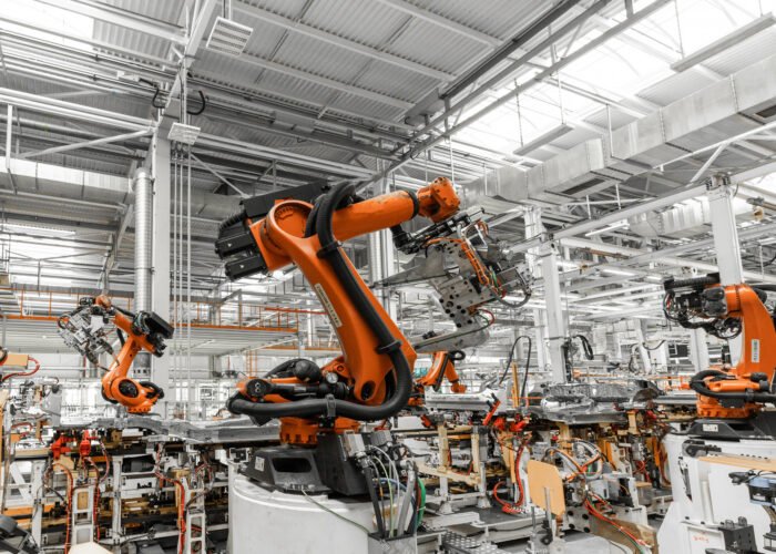 Photo of automobile production line. Welding car body. Modern car assembly plant. Auto industry.