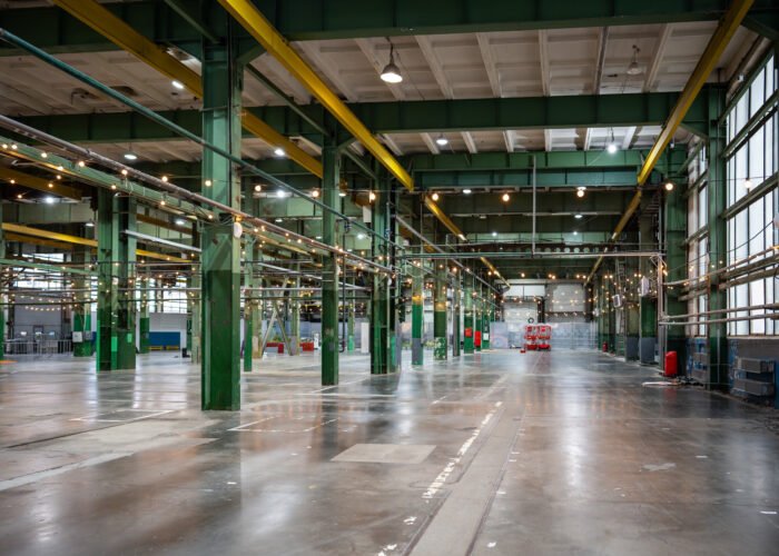 Interior of large empty industrial factory for metalworking operations. Heavy production and industrial efficiency, large scale production, engineering robust infrastructure, plant storage, workhouse