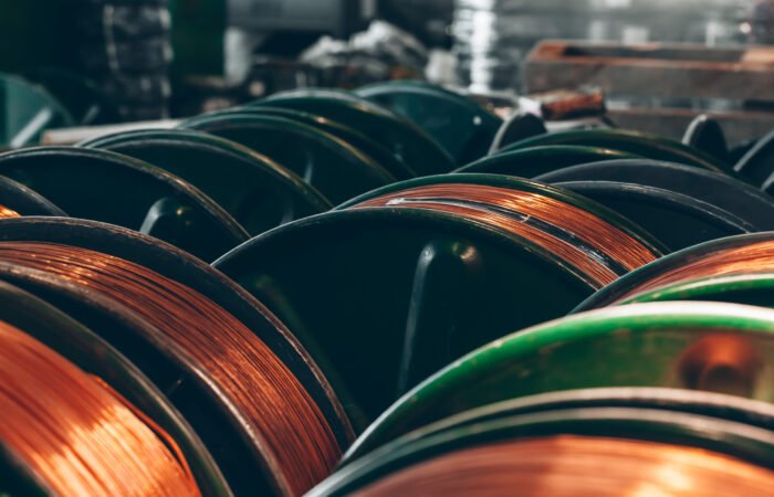 Copper wire reels in cable factory close up photo